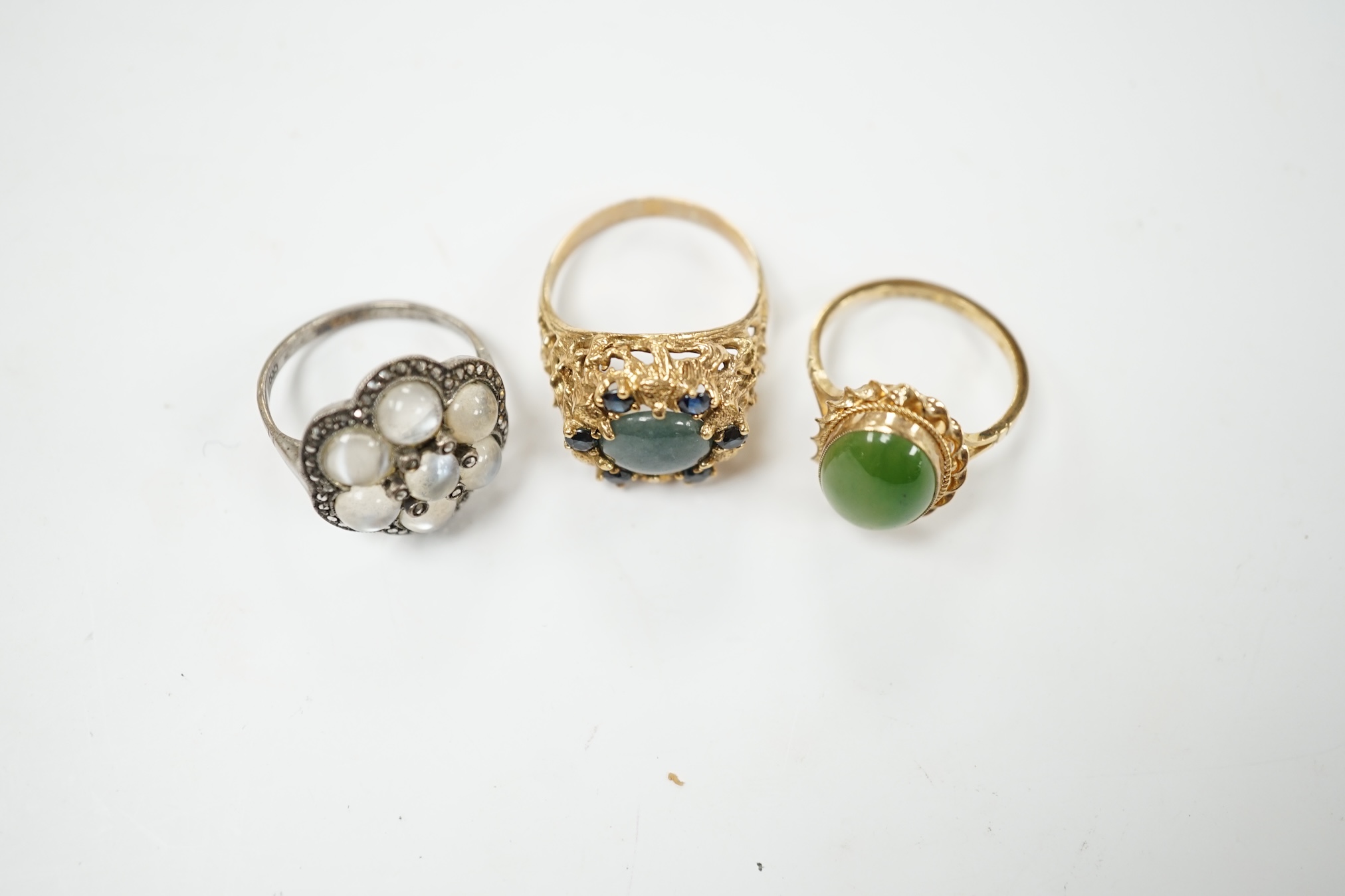 A 9ct gold and nephrite set ring, size P, one other 9ct and gem set ring and a German? Arts & Crafts 835, moonstone and marcasite cluster set ring. Condition - fair